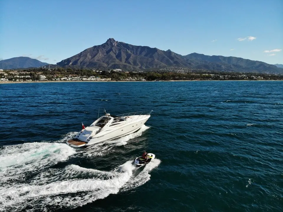 Vibe under way off Marbella with a jet ski alongside