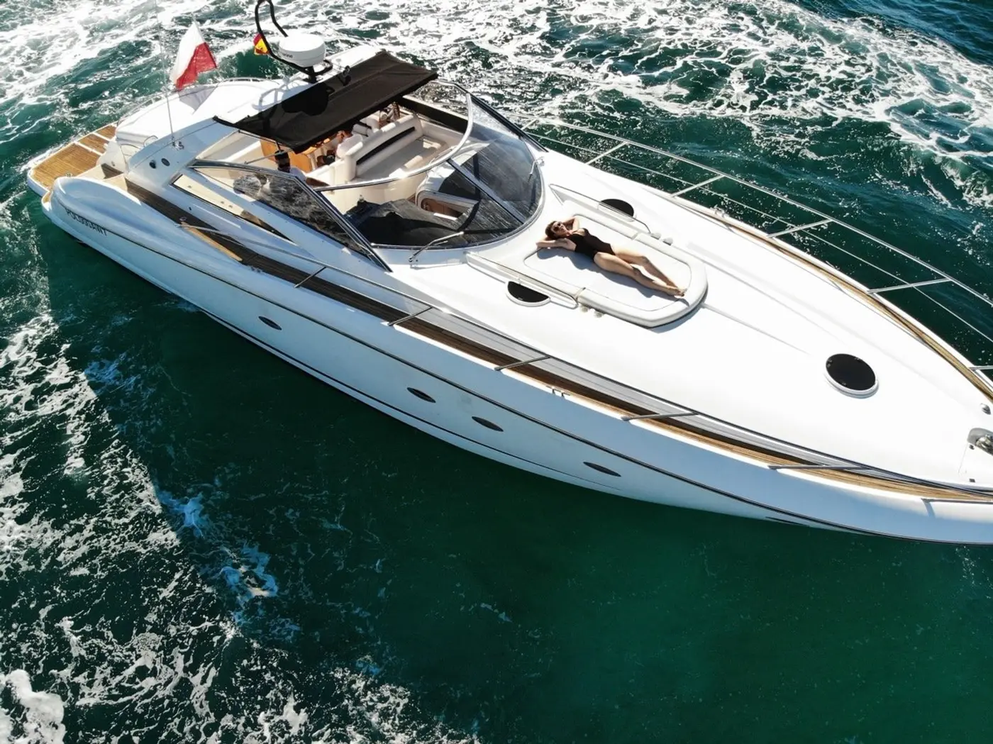 Guest on the bow sun pad of Sunseeker Predator 55 Vibe
