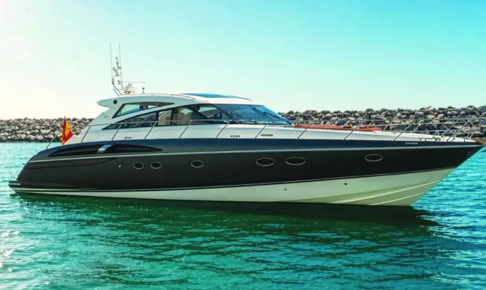 Princess V58 Candela in profile beside the harbour wall