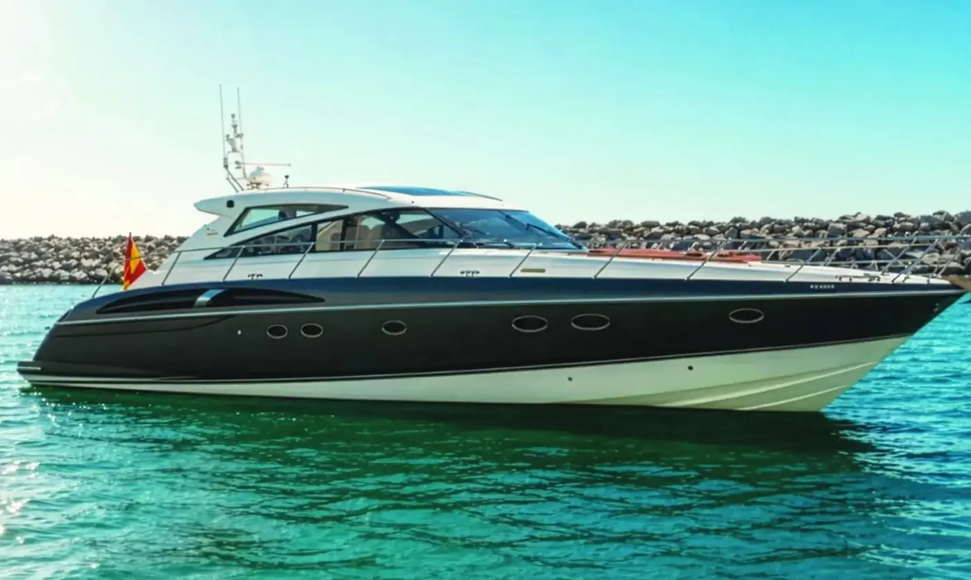 Princess V58 Candela in profile beside the harbour wall