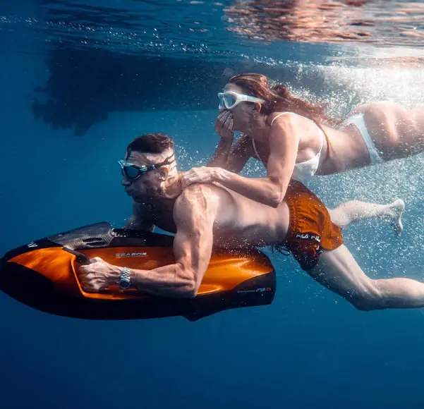 Two guests riding a SeaBob underwater