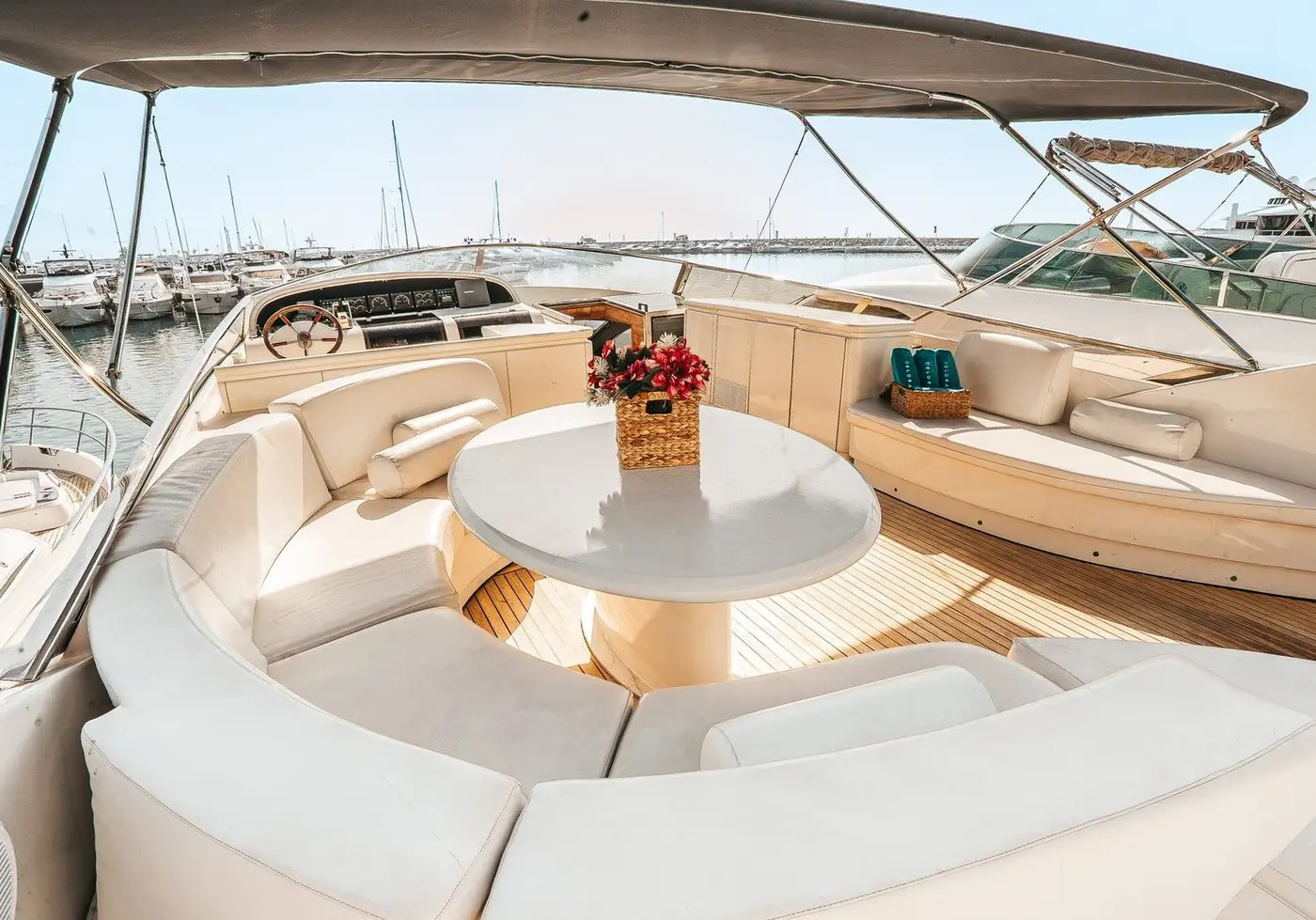 Flybridge sun deck with curved seating around a round table