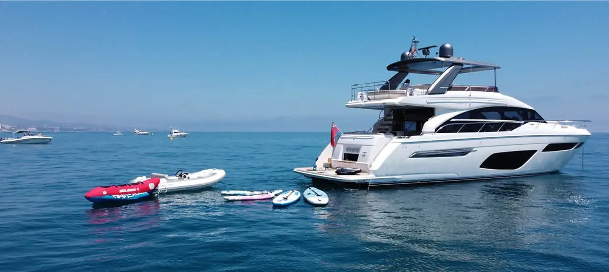 Amante at anchor with paddle boards and tender alongside