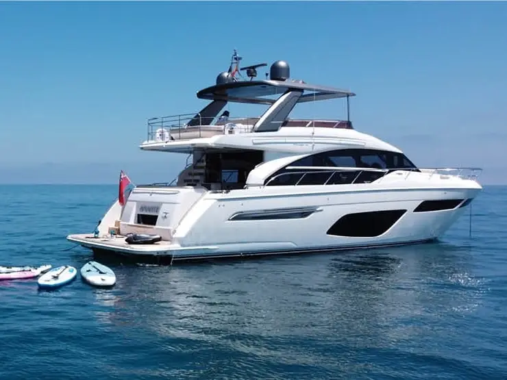Amante at anchor with paddle boards and tender alongside